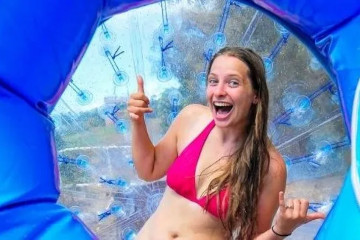 a young girl holding a blue umbrella