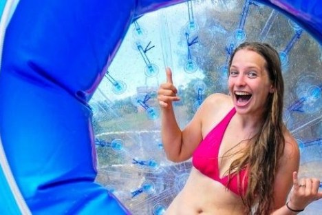 a young girl holding a blue umbrella