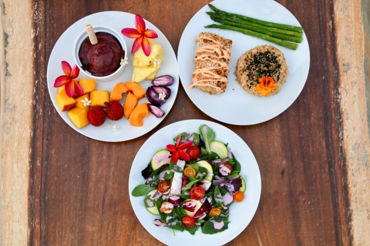 a bowl of fruit sitting on top of a wooden table